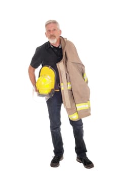 A middle age firefighter man standing from front with his jacket over.his shoulder and helmet in his hand, isolated for white background.