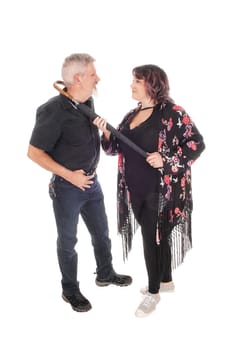 A middle age couple in a close up image having an argument and the.wife put a umbrella around man's neck, isolated for white background.