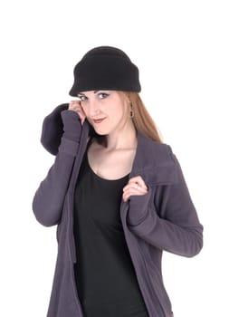 A beautiful brunette woman standing in a winter coat and hat,.looking into the camera, isolated for white background.
