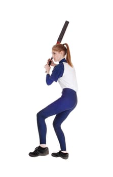 A young slim woman playing softball, swinging her bad to hit the ball.in a blue uniform, isolated for white background.