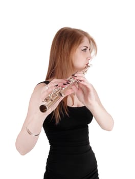 A gorgeous young woman standing in a black dress and playing the.flute, with long brunette hair, isolated for white background.