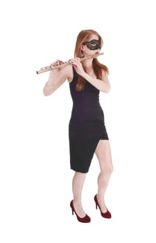 A gorgeous young woman standing in a black dress and playing the.flute, wearing a black mask over the eyes, isolated for white background.