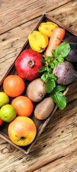 Box with apple, tangerine, lime and pomegranate.Healthy lifestyle concept