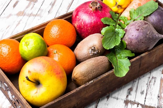 Box with apple, tangerine, lime and pomegranate.Healthy lifestyle concept