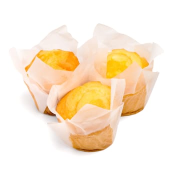 Closeup of a Magdalena Typical Spanish Plain Muffin. Sweet Food or Dessert. Three Fresh Baked Muffin Isolated on White Background in American Style. Irresistible Tasty Cake.