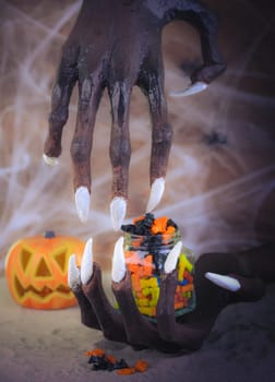 Pinhole effect Halloween witch hands, candy and pumpkin ornament