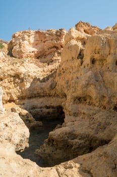 A pool of natural sea water between sandstone cliffs at Algar Seco. Carvoeiro Algarve Portugal.