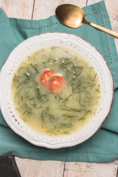 Caldo verde popular soup in Portuguese cuisine. traditional ingredients for caldo verde are potatoes, collard greens , olive oil and salt. Additionally garlic or onion may be added.