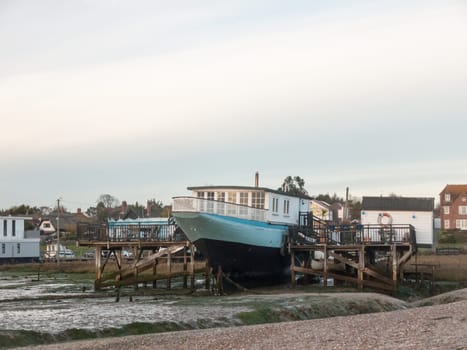 parked old oyster boat west mersea sea front home  west mersea, essex, england, uk