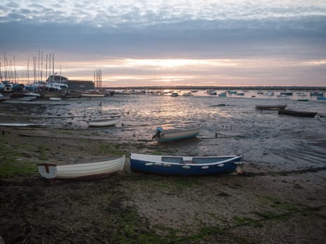 sun set sky dramatic clouds sea front beach harbor marina boats moored landscape  west mersea, essex, england, uk