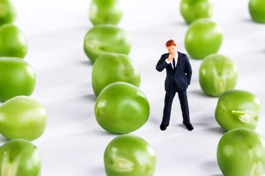 Figure of a businessman with fresh peas