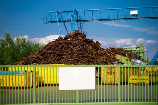 Site of a scrap yard with container and crane