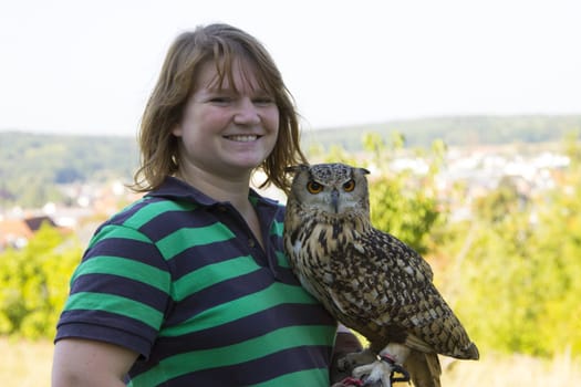 Young woman holding Indian eagle owl female