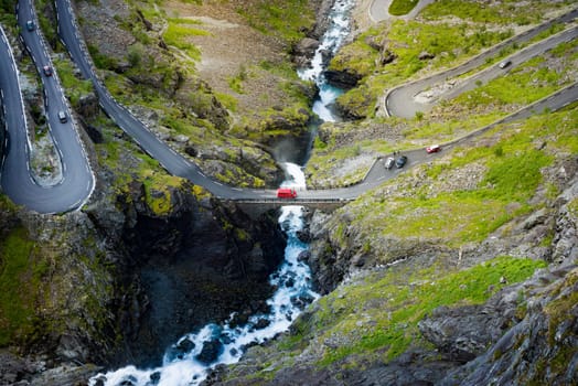 Trollstigen mountain road. Bridge over river with waterfall. Cars on serpentine. Auto travel in Norway, Europe, Scandinavia