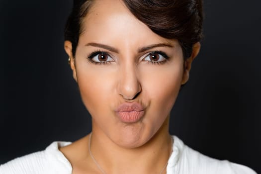 Beautiful woman with pucker lips facial expression