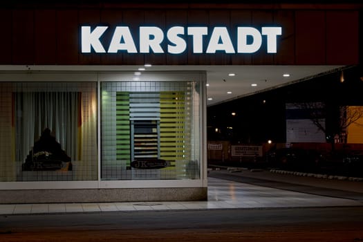 Exterior view of a Karstadt branch in Magdeburg at night. The first Karstadt department store opened in 1881