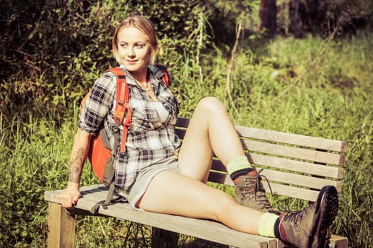Hiker woman resting on bench
