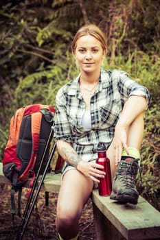 Pretty young hiking woman resting