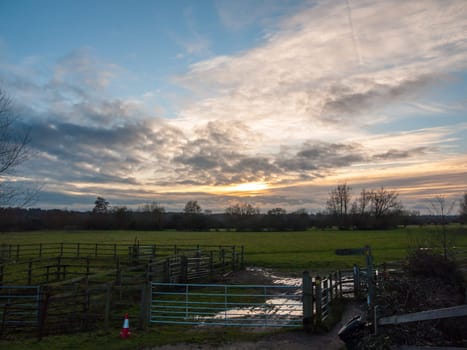 sunset over countryside field with fence in front landscape  essex  england  uk