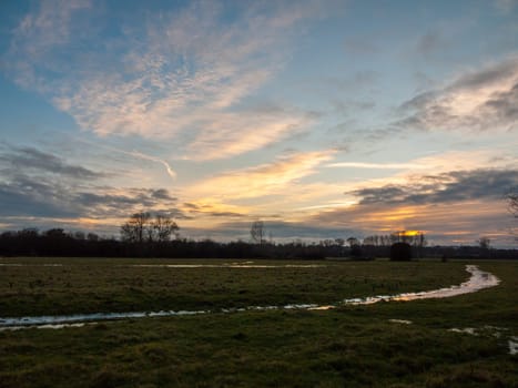 empty wet grass field low light sunset landscape dedham plain empty no people dramatic sky  essex  england  uk