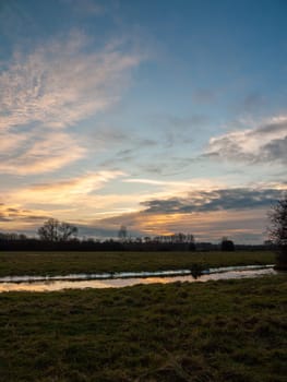 empty wet grass field low light sunset landscape dedham plain empty no people dramatic sky  essex  england  uk