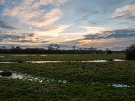 empty wet grass field low light sunset landscape dedham plain empty no people dramatic sky  essex  england  uk