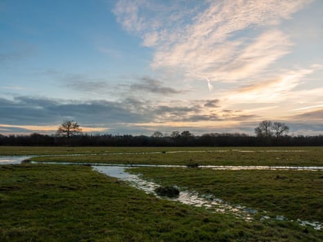 empty wet grass field low light sunset landscape dedham plain empty no people dramatic sky  essex  england  uk