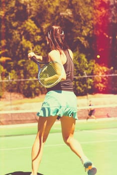 Young teenage woman playing tennis