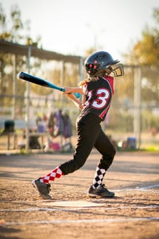 Child playing softball or baseball game