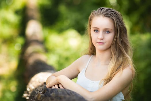 Pretty blond teen girl outside