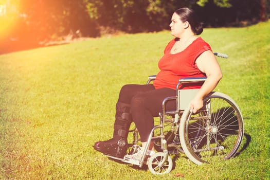 Woman with broken leg in wheelchair