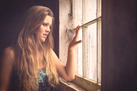 Beautiful woman looking out window