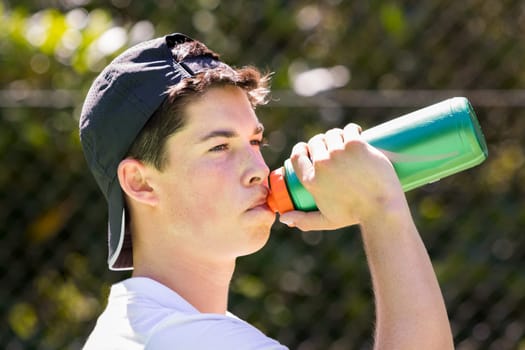 Young man drinking water from bottle