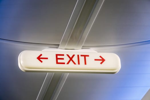 Emergency Exit Sign in the passenger cabin of an airplane