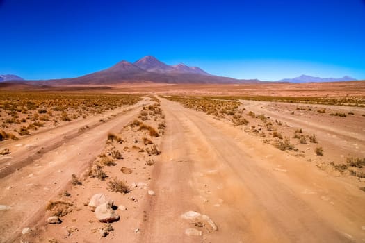 Sandy and gravel desert road through remote part of southern Altiplano, Bolivia