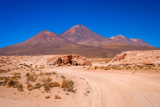Sandy and gravel desert road through remote part of southern Altiplano, Bolivia