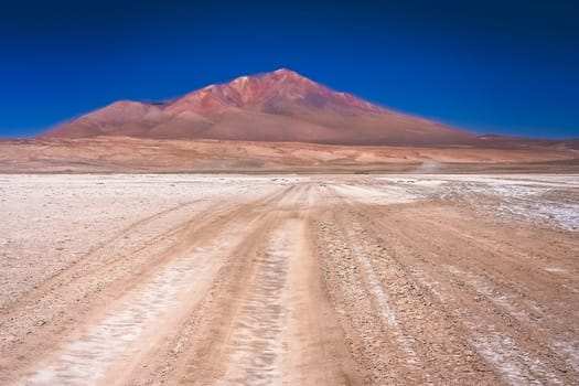 Sandy and gravel desert road through remote part of southern Altiplano, Bolivia