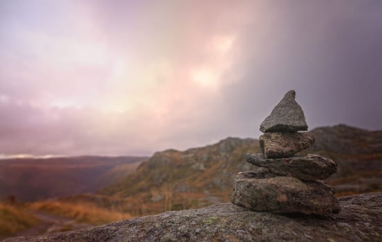 Zen balanced small pile of stacked stones on a walking path starting on top of Mount Ulriken in Bergen, Norway