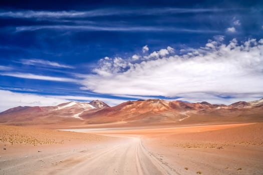 Sandy and gravel desert road through remote part of southern Altiplano, Bolivia