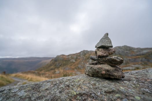 Zen balanced small pile of stacked stones on a walking path starting on top of Mount Ulriken in Bergen, Norway