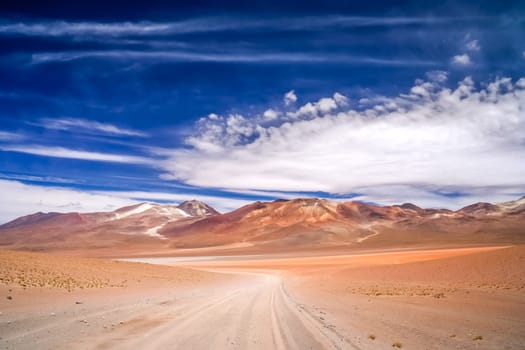 Sandy and gravel desert road through remote part of southern Altiplano, Bolivia