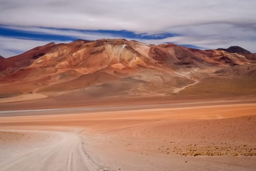 Sandy and gravel desert road through remote part of southern Altiplano, Bolivia