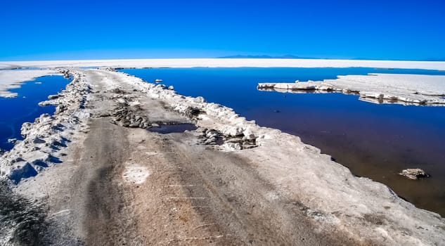 Remote empty road through the Salar de Uyuni in Bolivia