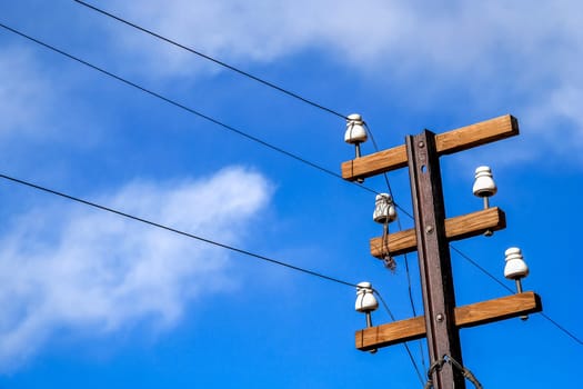 Electric pole in the countryside with blue sky background