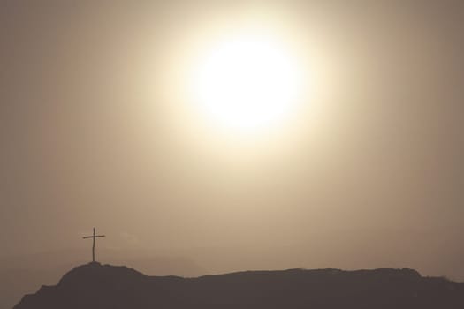 Cross on the rock in argentinian mountains