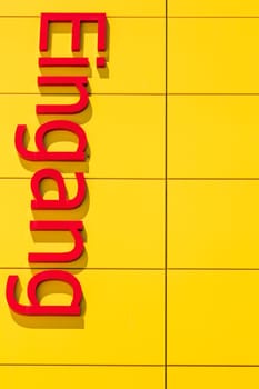 Large red letters with the lettering - ENTRANCE - on yellow background