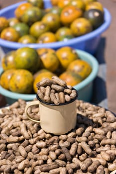african street vendors selling peanuts, monkey oranges