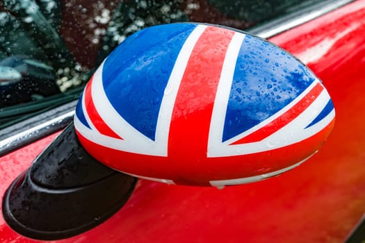 Car mirror from the outside with flag of Great Britain
