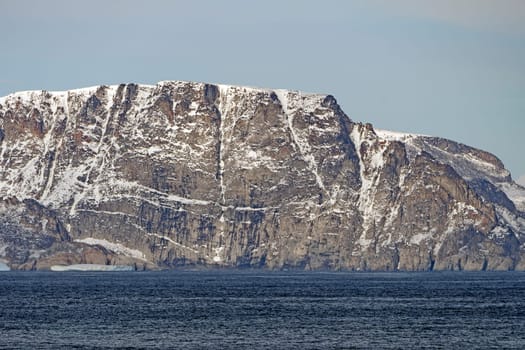Dramatic Cliffs with Early Fall Snow on Baffin Island in Nunavut, Canada