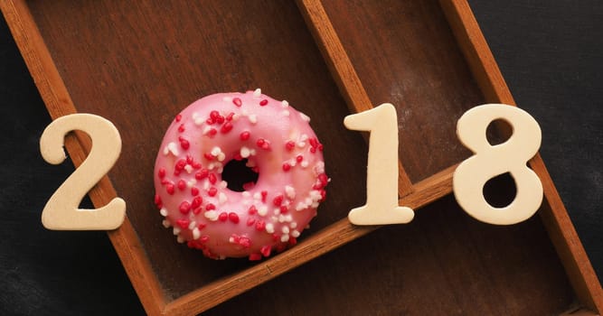 Sweet pink donut with the number 2018, sweet New Year concept